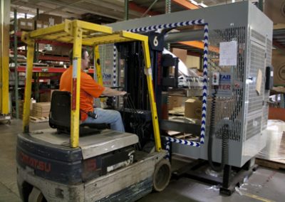 Forklift driver wrapping pallet load with TAB Wrapper Tornado