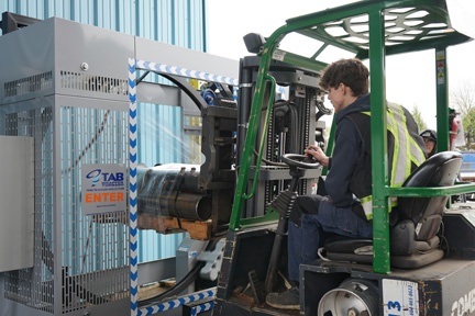 PItt Meadows Plumbing and Mechanical forklift operator using TAB Wrapper Tornado orbital stretch wrapper outdoors