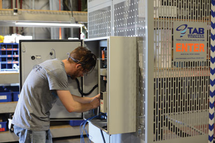 Worker assembles TAB Wrapper Tornado orbital wrapper panel