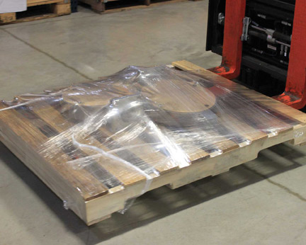 Parts on pallet secured in stretch wrap by TAB Wrapper Tornado orbital wrapper