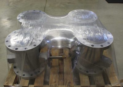 Four metal valves stretch wrapped to a pallet using the TAB Wrapper Tornado orbital wrapper